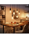 Bombilla inteligente Philips HueWhite 7W 2100K 550lm A60 E27 en un comedor