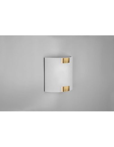 Applique PURA petit détail en bronze sur un mur terne